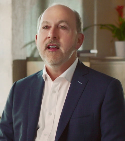 Watch video. Still of Peter McAllister, MD, FAAN, speaking on using POD technology and how it differs from other nasal sprays